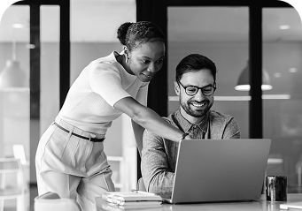 Two people looking at a laptop 