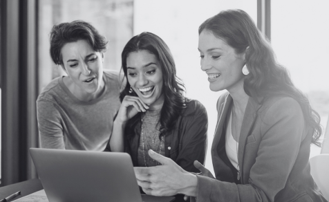 Women talking next to computer