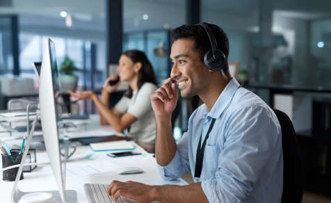 Man working on computer talking to client