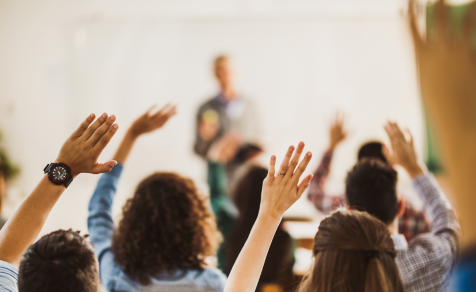 People raising their hand during a live demo