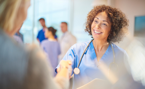 Healthcare professional shaking hands with client