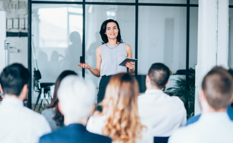 Woman holding seminar to group of clients