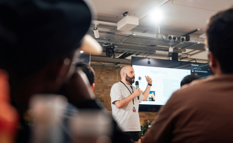 Man holding tech seminar to group of people in room