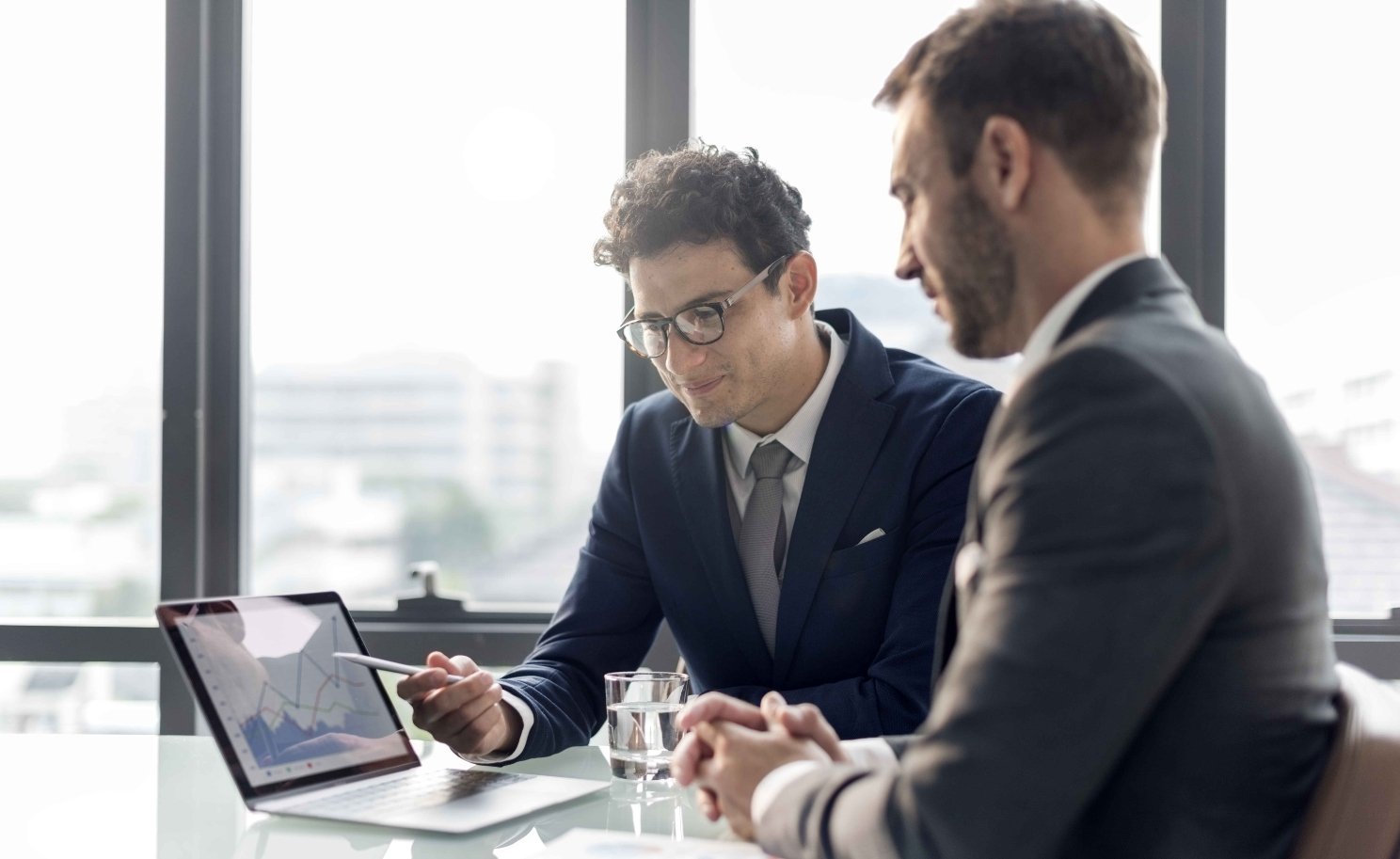 Man helping financial client with advisory services on tablet