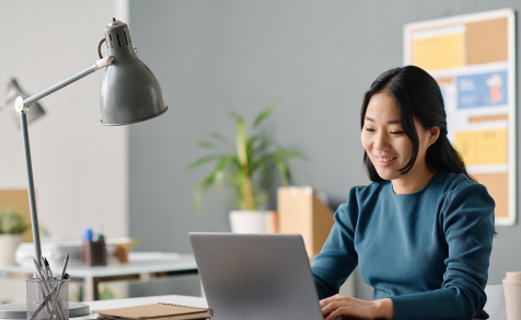 Women smiling using laptop